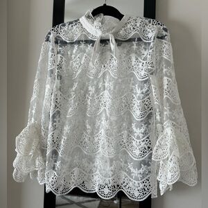 White lace open back top with bow tie and bell sleeves